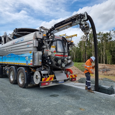 Elite Liquid Waste's truck operator is operating the specialised vacuum equipment to clean up the blockage of the drain.