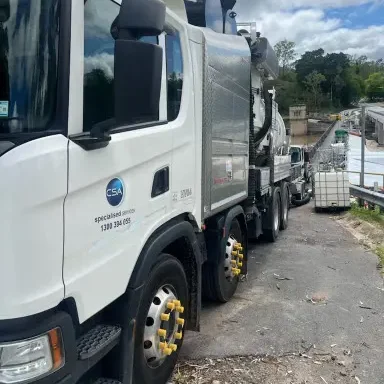 Elite Liquid Waste's truck operator is operating the specialised vacuum equipment to clean up the blockage of the drain.